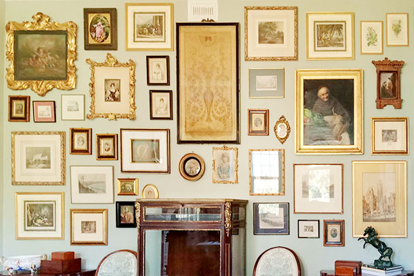 ornate-picture-frames-hanging-on-green-wall